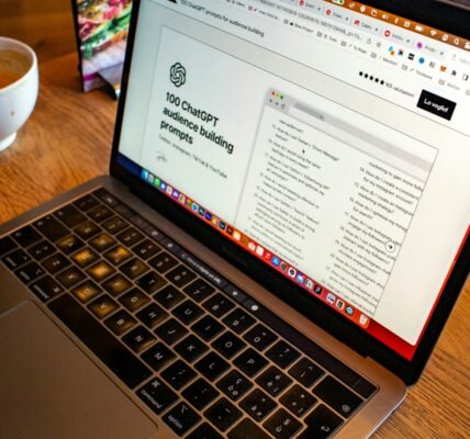 a laptop computer sitting on top of a wooden table
